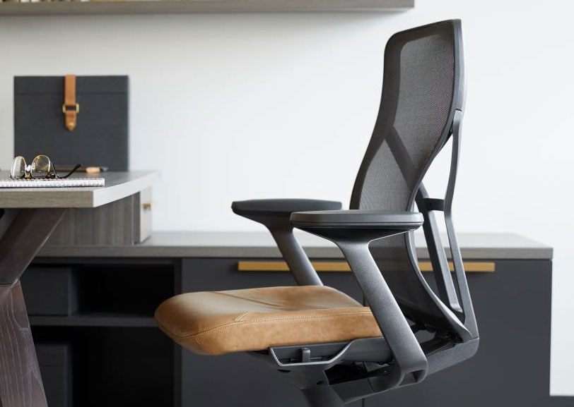 Employee training room with mobile tables, white task chairs, monitors, and abundant natural light