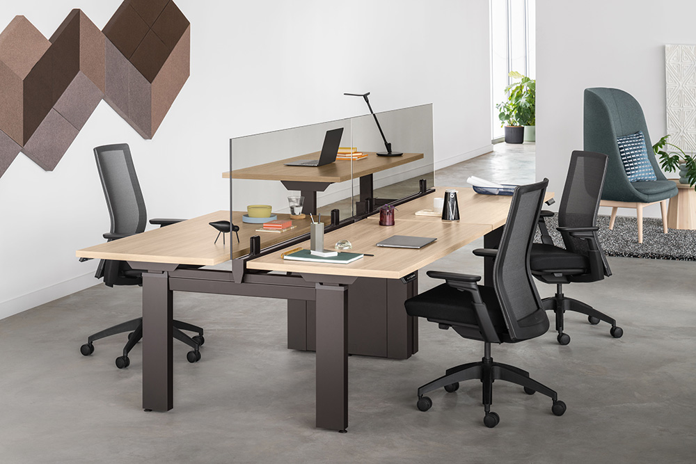 Open workstations with Universal privacy screens, monitor arms, task chairs, and shared storage