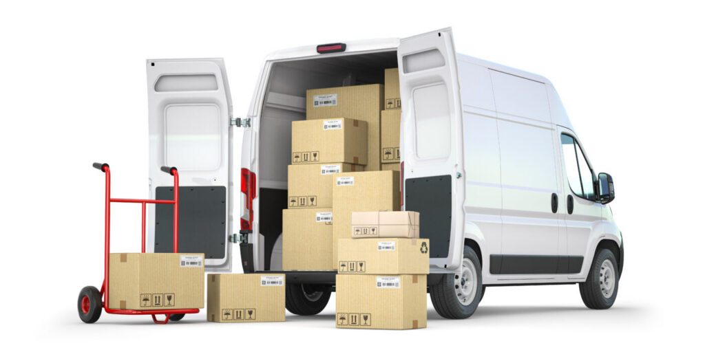 Commercial office furniture and moving boxes loaded into a van for workplace relocation services