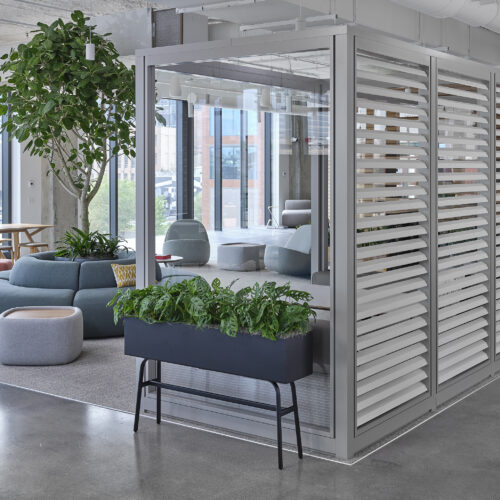 Glass-walled lounge area at the Allsteel Fulton Market Experience Center in Chicago, IL