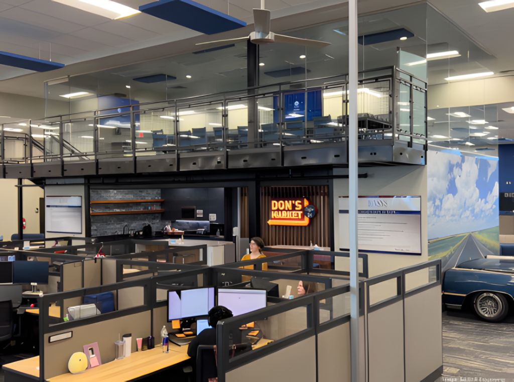 Contemporary workplace café with glass walls, pendant lighting, counter seating, and wood finishes