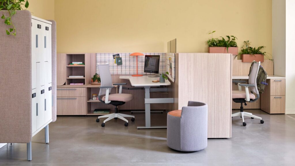 OFS NeoCon lounge with pink seating, tables, and soft architectural dividers in Chicago, IL