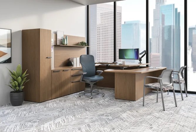 Modern executive office with a wood desk, ergonomic chair, guest seating, storage cabinets, and floor-to-ceiling city views.