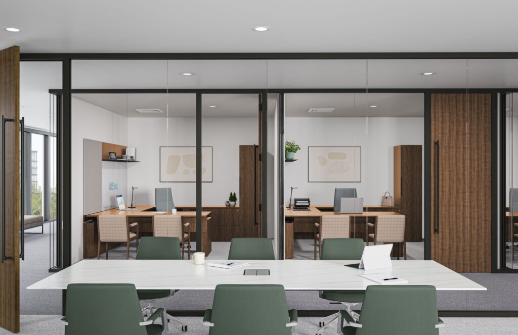 Contemporary meeting room with a large conference table, green task chairs, and glass-fronted private offices with wood furnishings.
