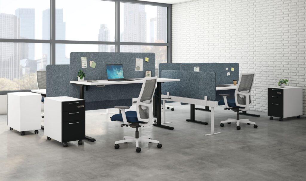 Open-plan office with adjustable workstations, ergonomic chairs, acoustic privacy panels, mobile filing cabinets, and large city-view windows.