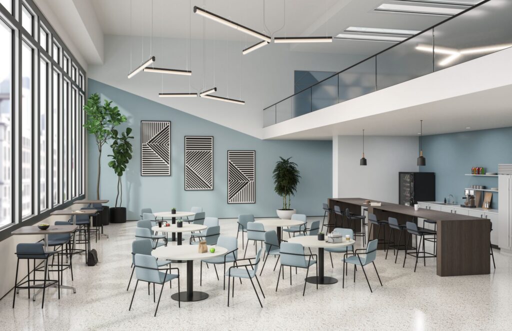 Spacious office café with round dining tables, counter seating, modern pendant lights, large windows, and a mezzanine level.